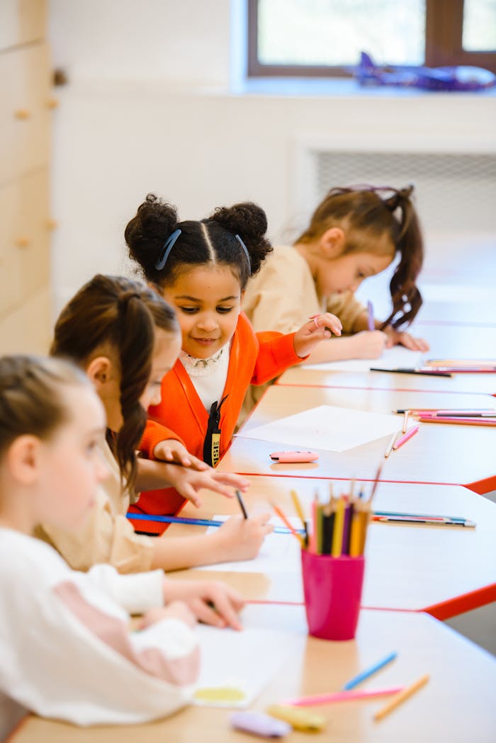 Joyful children drawing and learning in a bright, lively classroom setting.